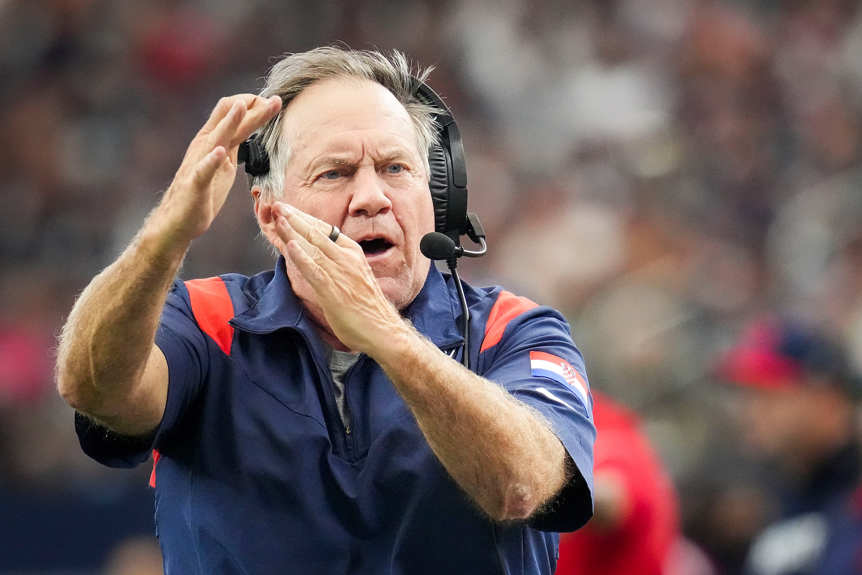 New England Patriots head coach Bill Belichick signals for a touchdown  during the first...