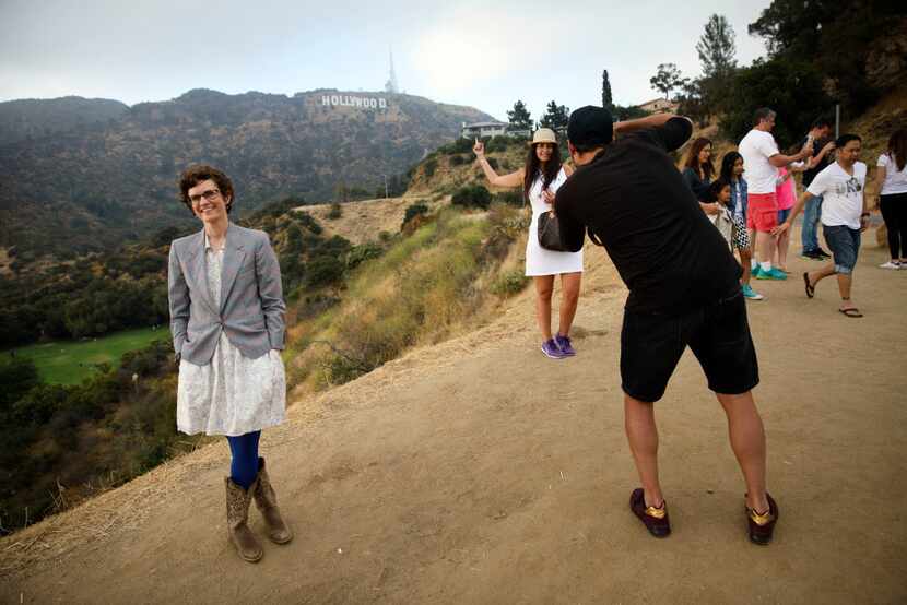 Author Merritt Tierce poses for a portrait next to tourists taking pictures near the...