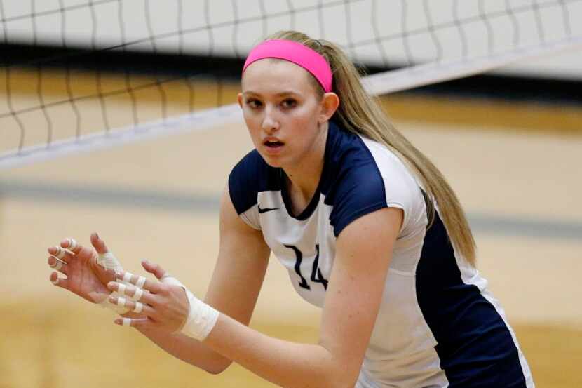 Flower Mound player Lauren Cox (14) prepares for a serve during a high school volleyball...