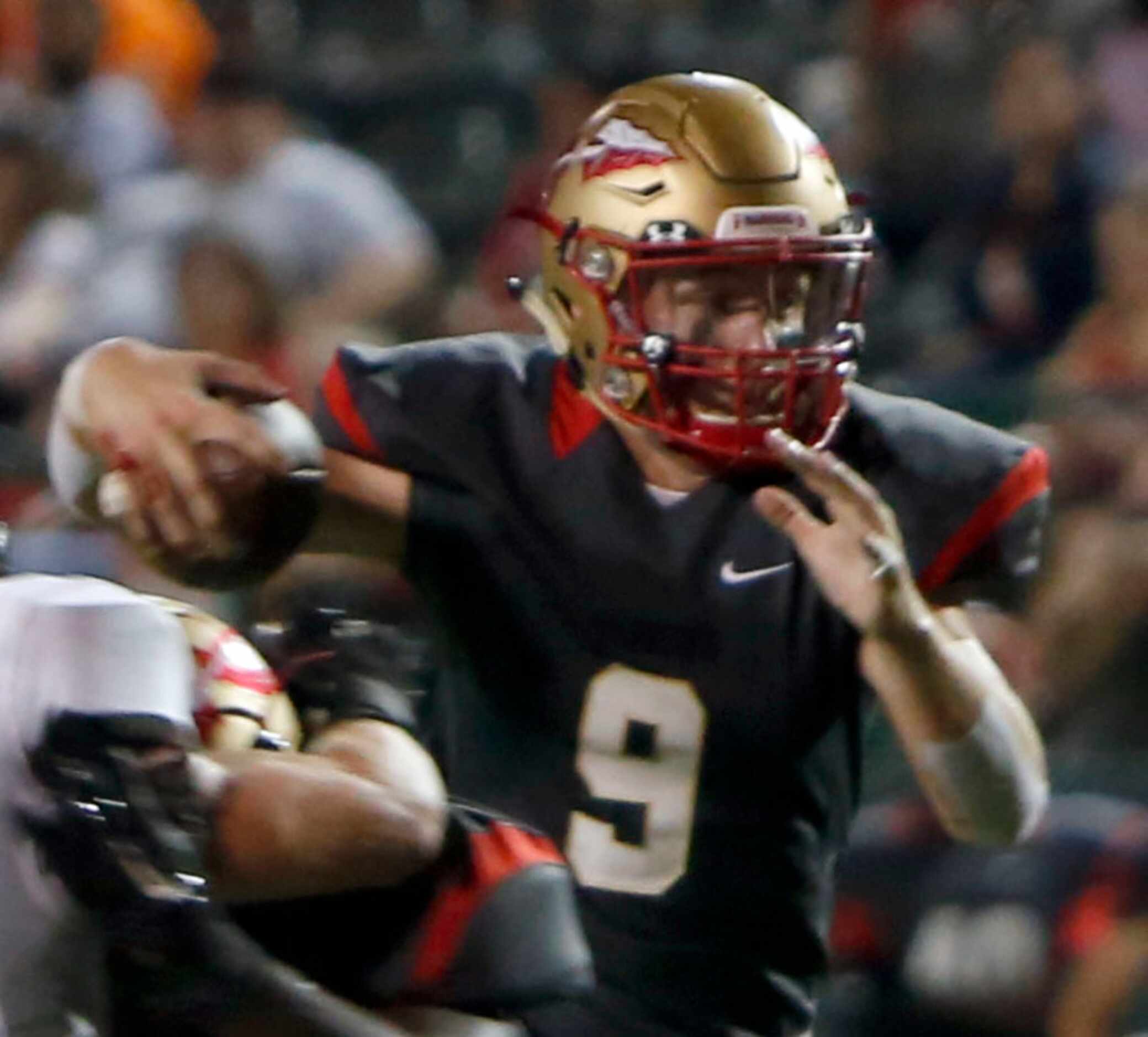 South Grand Prairie quarterback Drake Logan (9) looks for running room during first half...