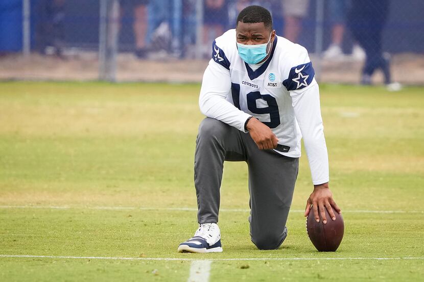 Dallas Cowboys wide receiver Amari Cooper watches from the sideline during a practice at...