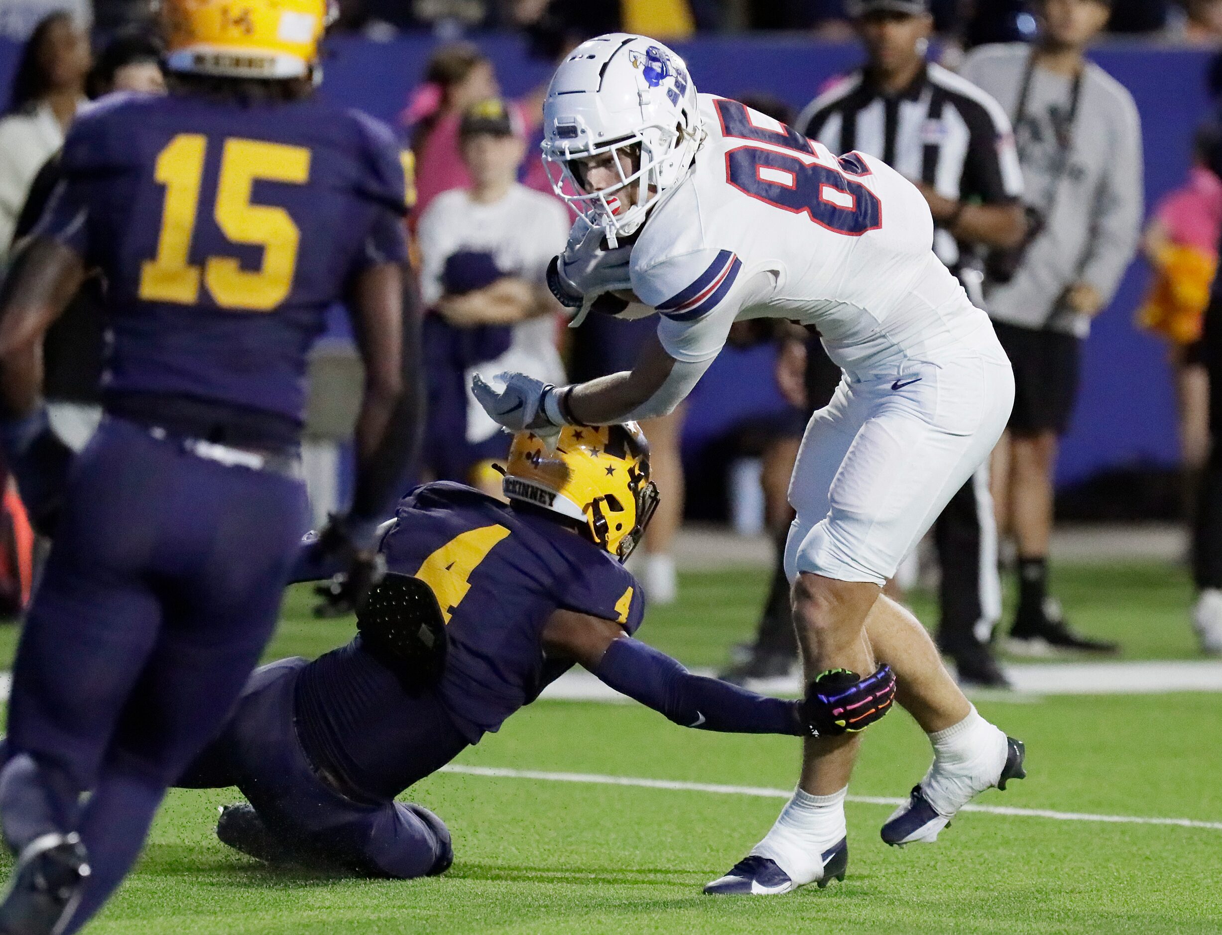 Allen High School tight end Gavin Akins (85) was tripped up just enough by McKinney High...