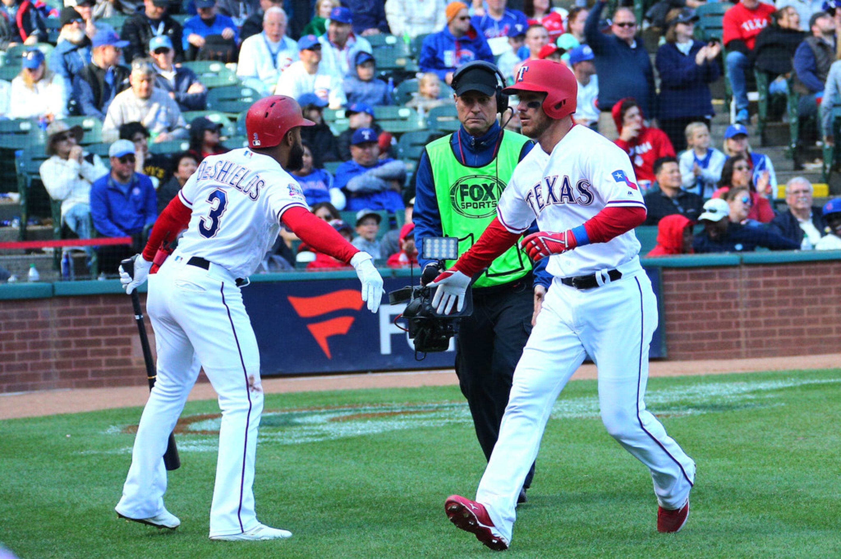 ARLINGTON, TX - MARCH 31: Jeff Mathis #2 of the Texas Rangers is congratulated by Delino...