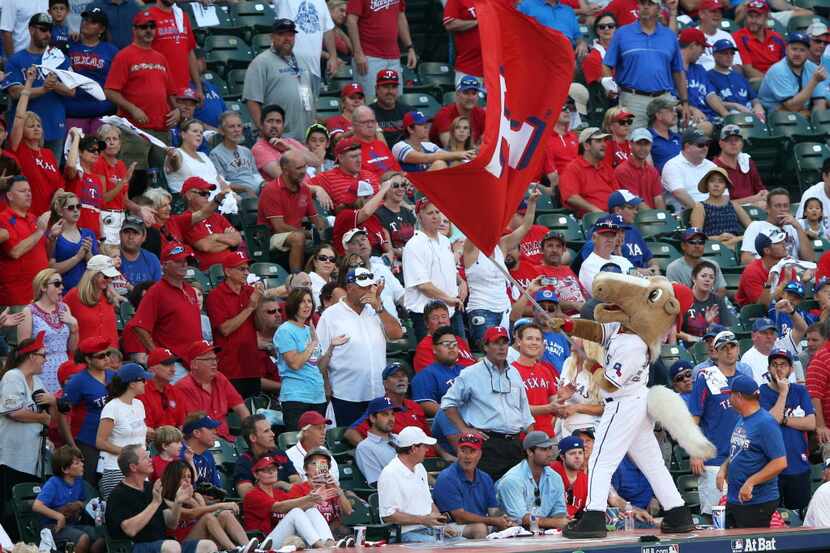 Texas Rangers mascot Captain attempts to rile the crowd up before the start of the bottom of...