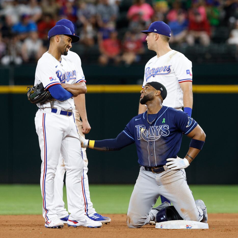 Tampa Bay Rays third baseman Yandy Diaz (2) talks with Texas Rangers second baseman Marcus...