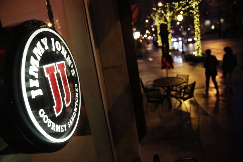 Pedestrians pass by a Jimmy Johnâs sandwich shop, Friday, Jan. 2, 2015, in Atlanta. A...