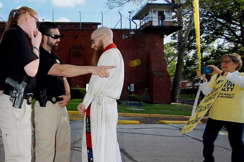  The Rev. Dr. Jeff Hood is confronted and arrested after crossing a police-tape barrier...