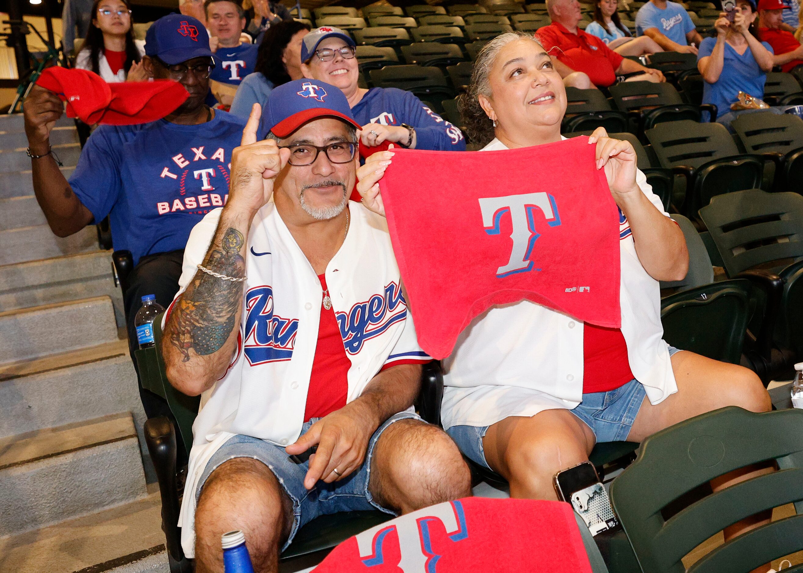 Texas Rangers fans Armando Montemayor of Arlington and his wife Emma Montemayor pose for a...