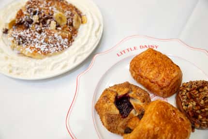 Breakfast items at Little Daisy include bananas foster pancakes, left, pain au chocolate,...