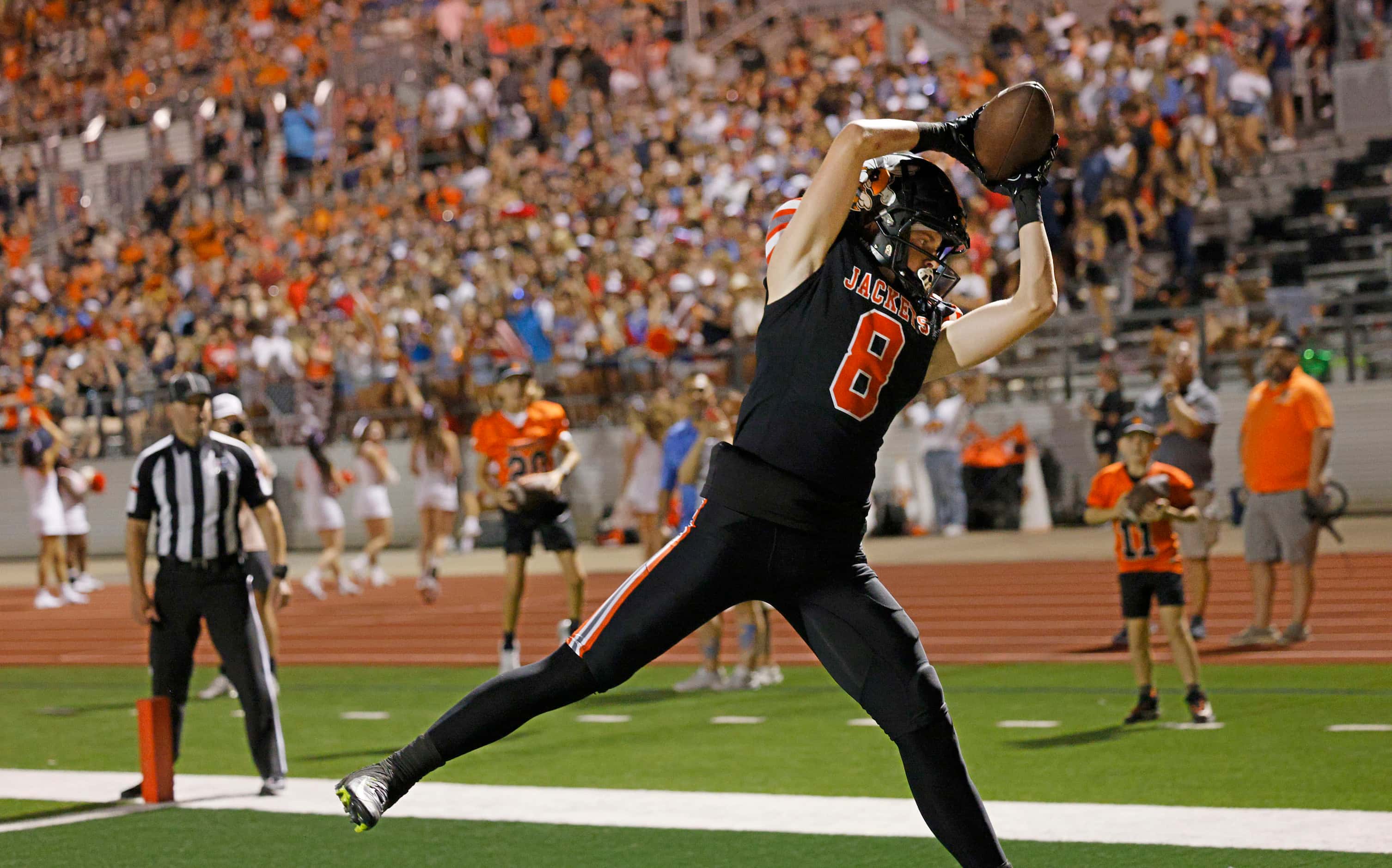 Rockwall's Tristan Gooch (8) catches a pass to score during the first half of a high school...