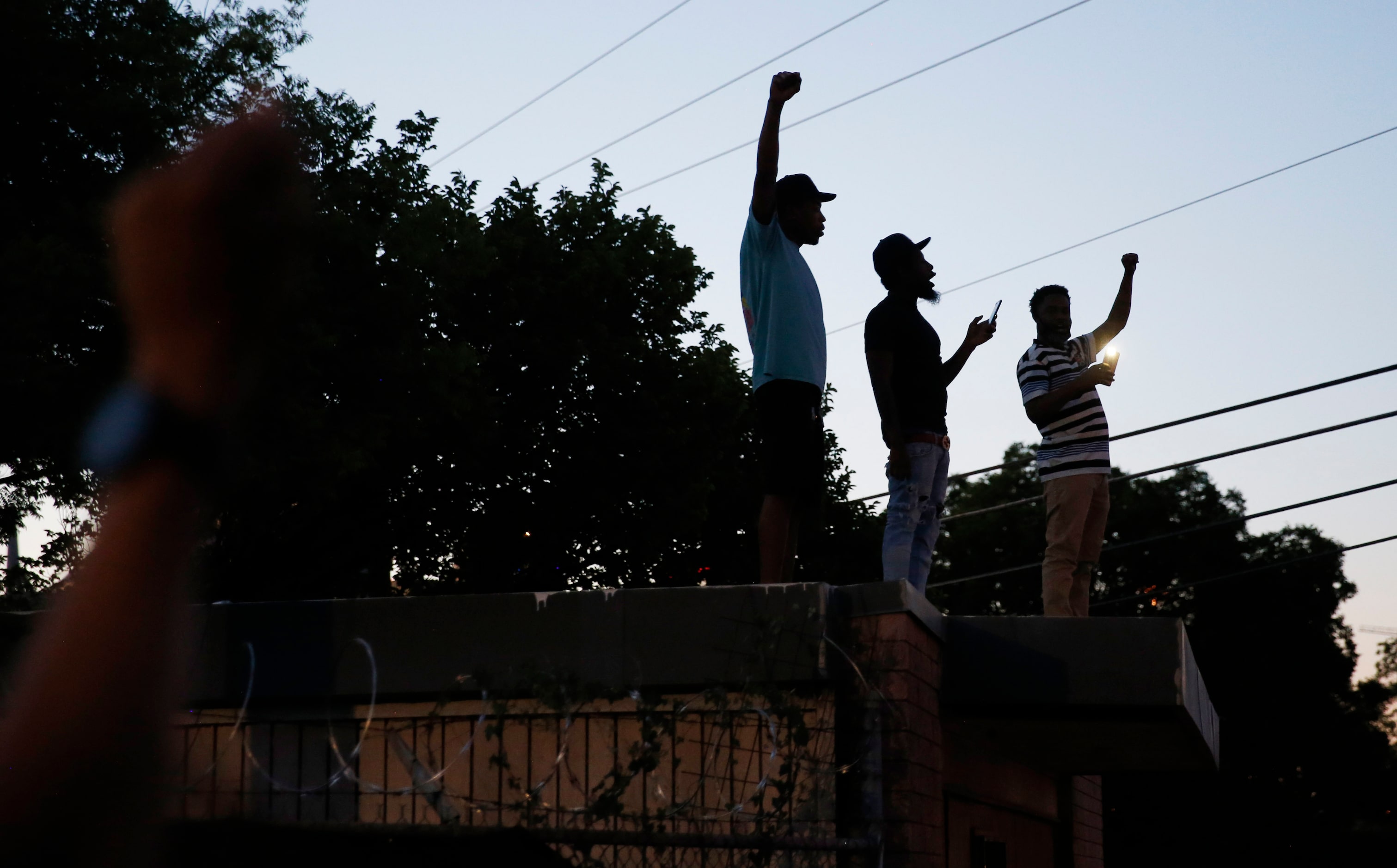 Protesters march during a demonstration against police brutality in downtown Dallas, on...