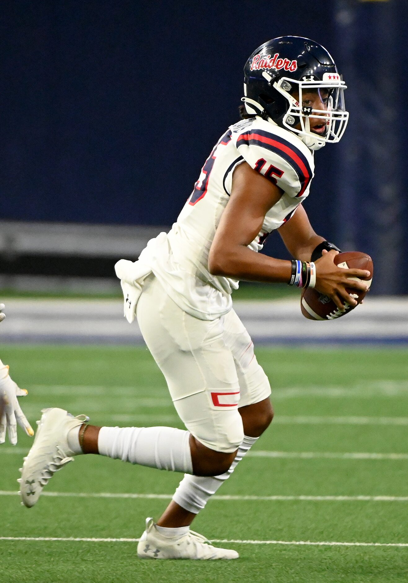 Denton Ryan’s Khalon Davis looks to pass downfield in the first half during a high school...