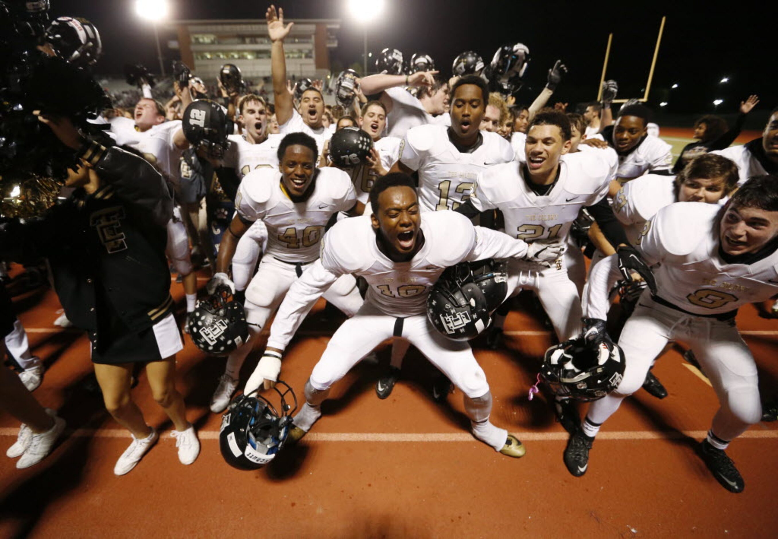 The Colony's Kyle Covington (10), Darius Mitchell (40), and Jalen Brown (21) and teammates...