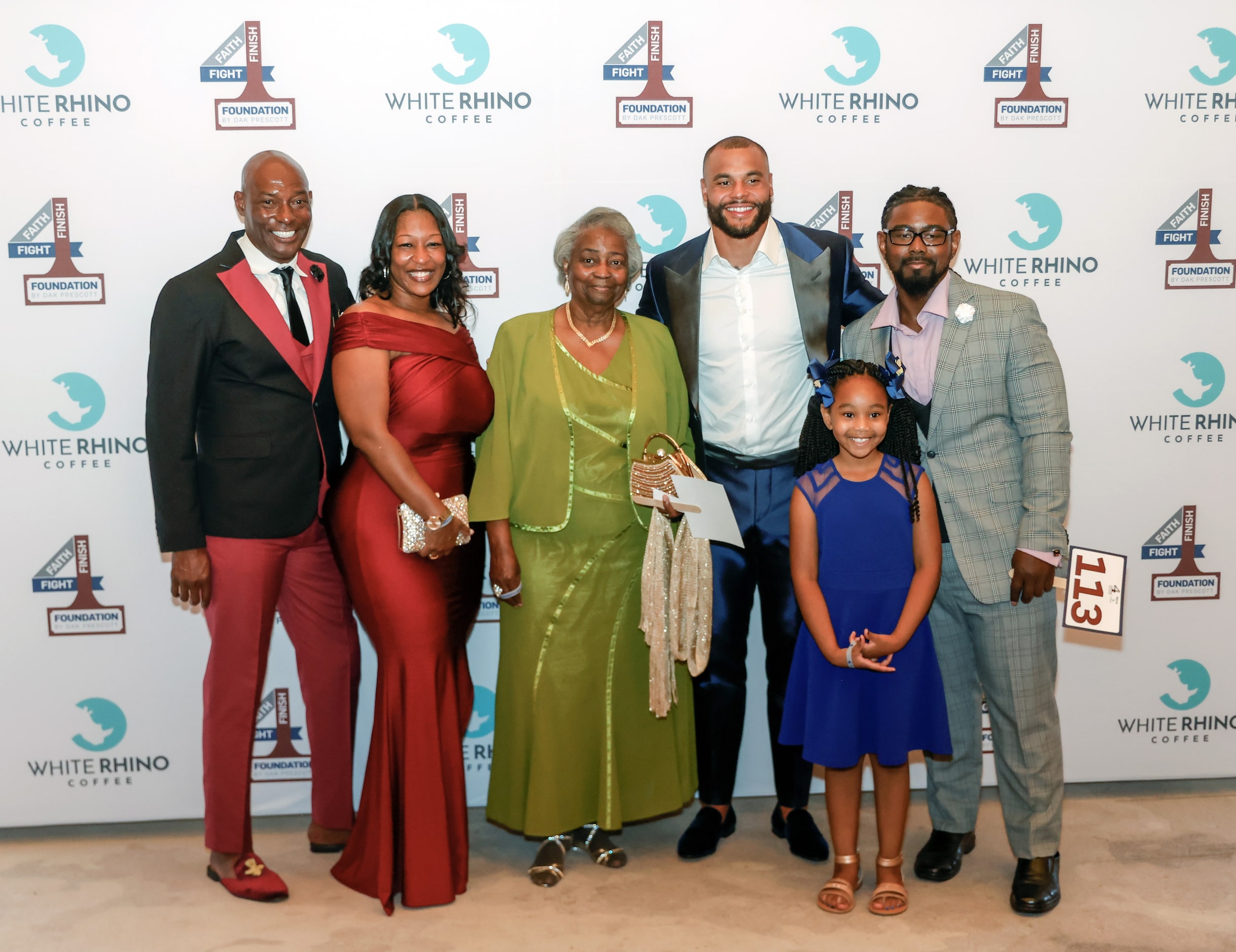 Founder and Dallas Cowboys quarterback Dak Prescott (center) poses with family and friends...