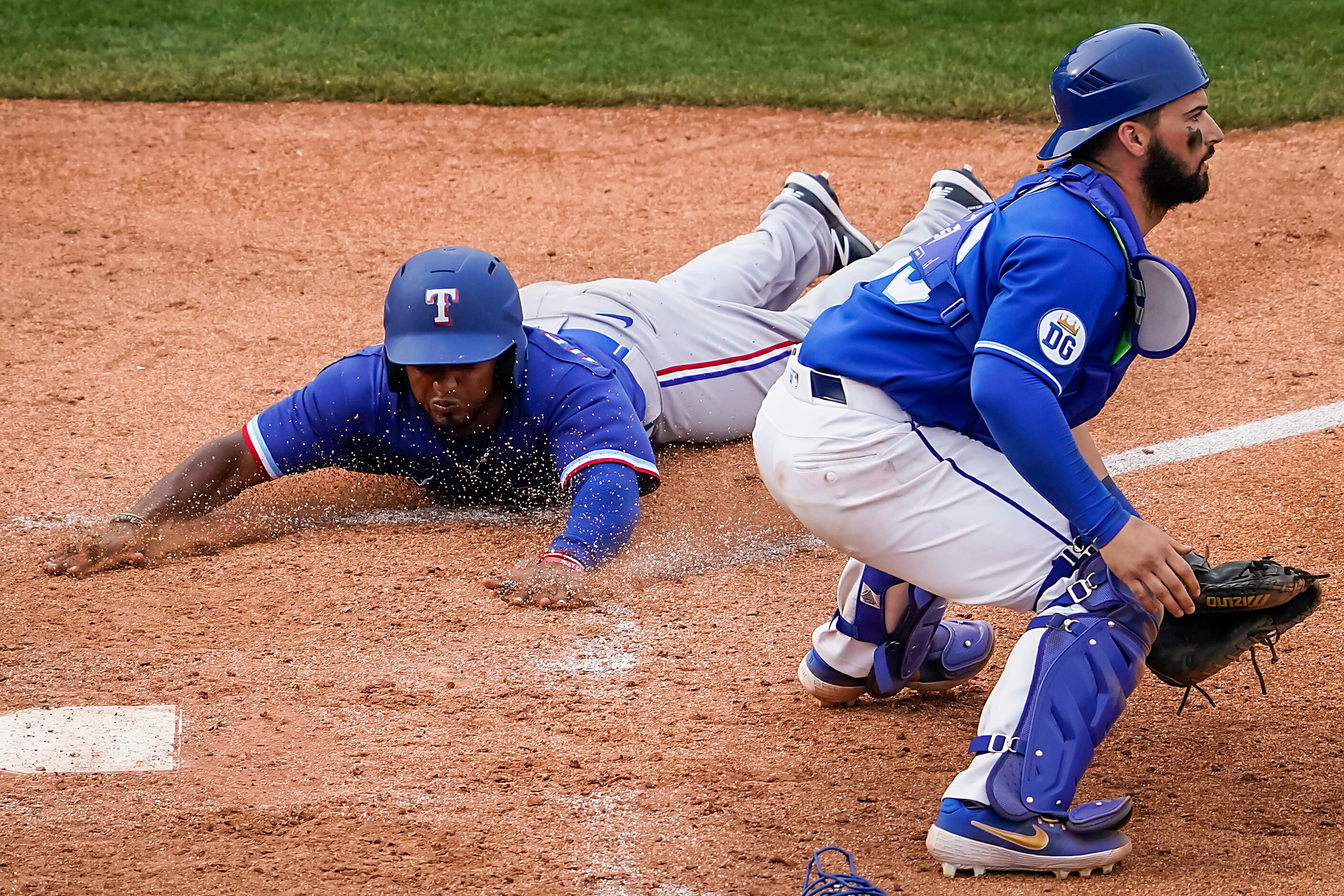 Texas Rangers pinch runner Yonny Hernandez scores past Kansas City Royals catcher Nick Dini...