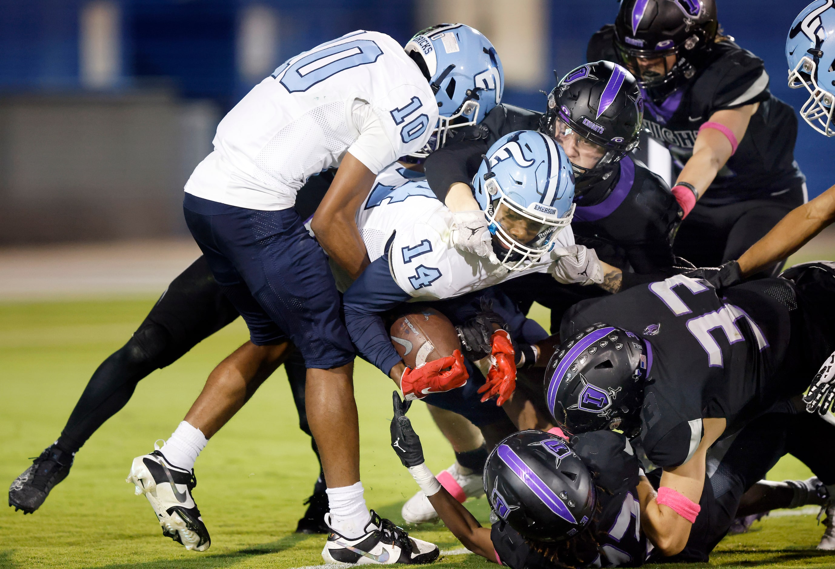 Frisco Emerson wide receiver Kelton Wafer (14) has help getting across the goal line on the...