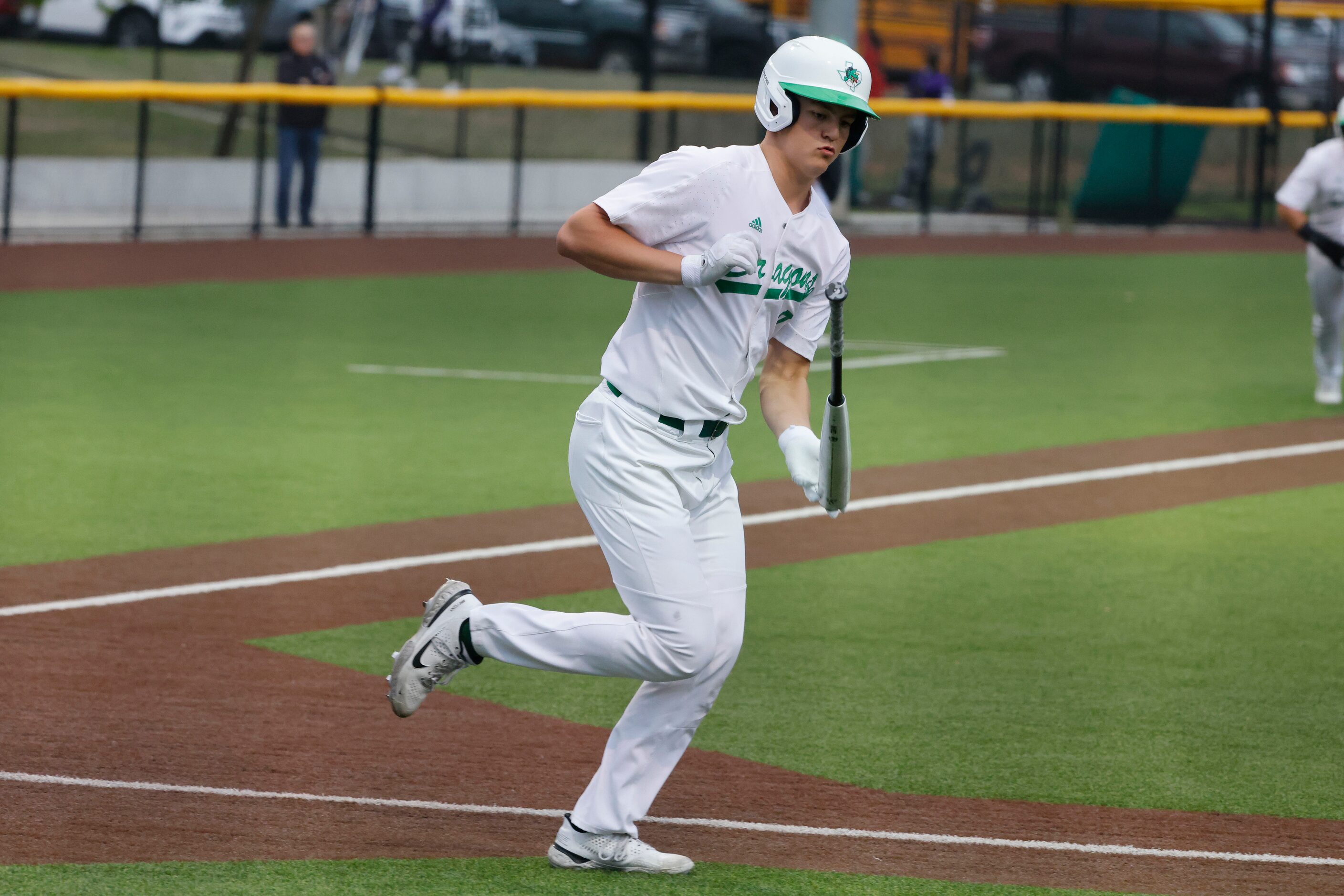 Southlake Carroll’s Owen Proksch flips  the bat as he draws a walk against Keller Timber...