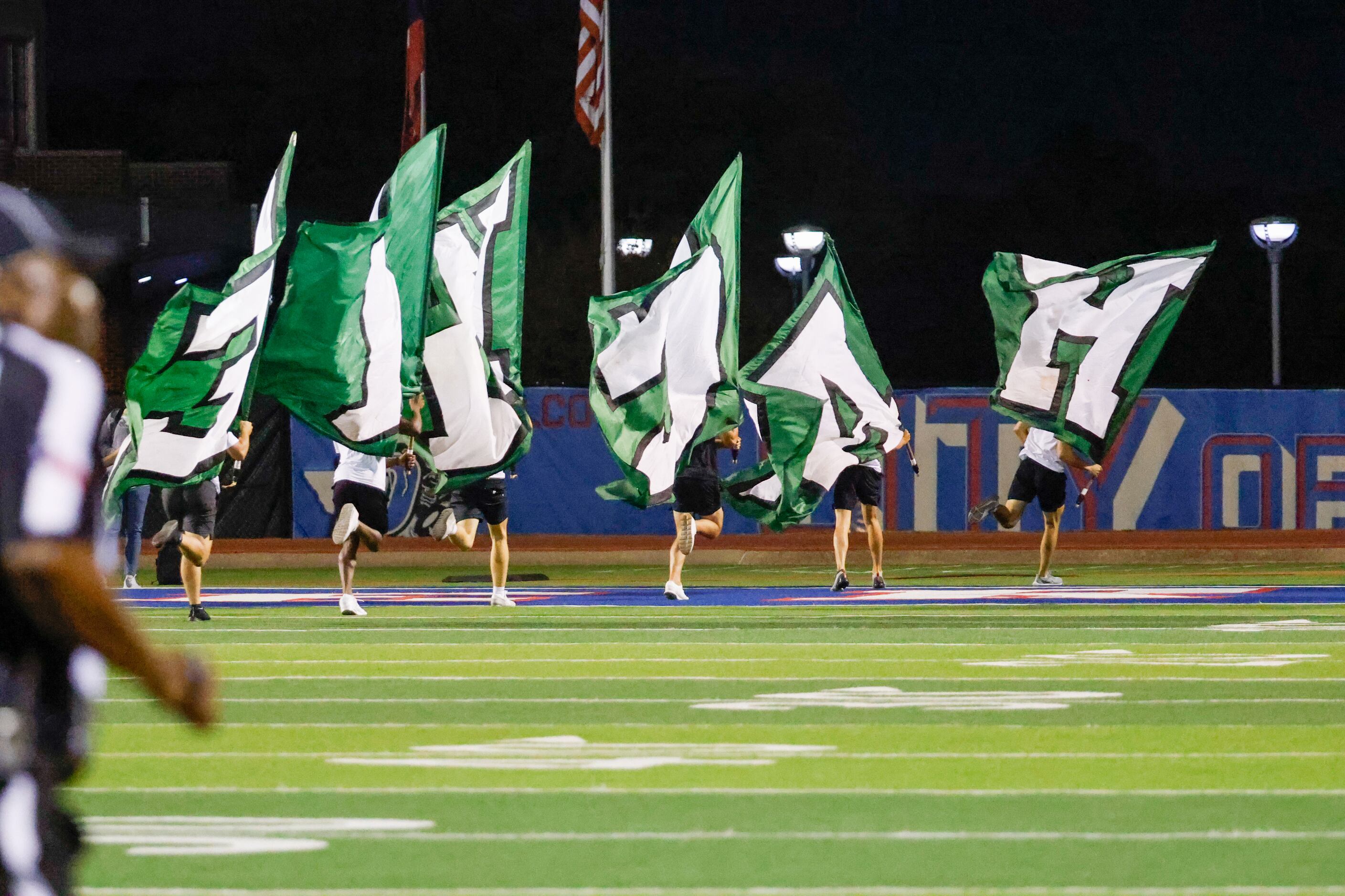 Waxahachie students run the line in celebration of the first touchdown in a game against...