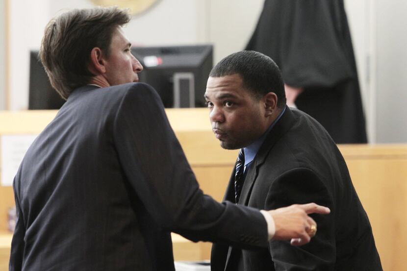Phillip Hayes, left, one of the defense attorneys for Franklin Davis takes a break at the...
