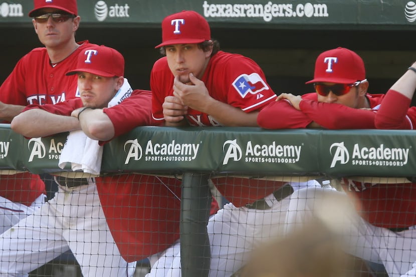 Texas starting pitcher Tanner Scheppers, second from left, watches the ninth inning from the...