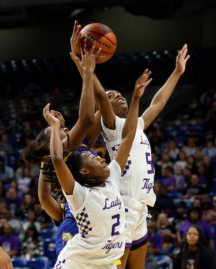 Dallas Lincoln Tigers Ar’jayla Elder (5) grabs a rebound over teammate Dallas Lincoln Tigers...