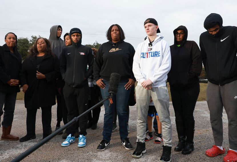 Members of the Duncanville boys basketball team and their families stand together waiting to...