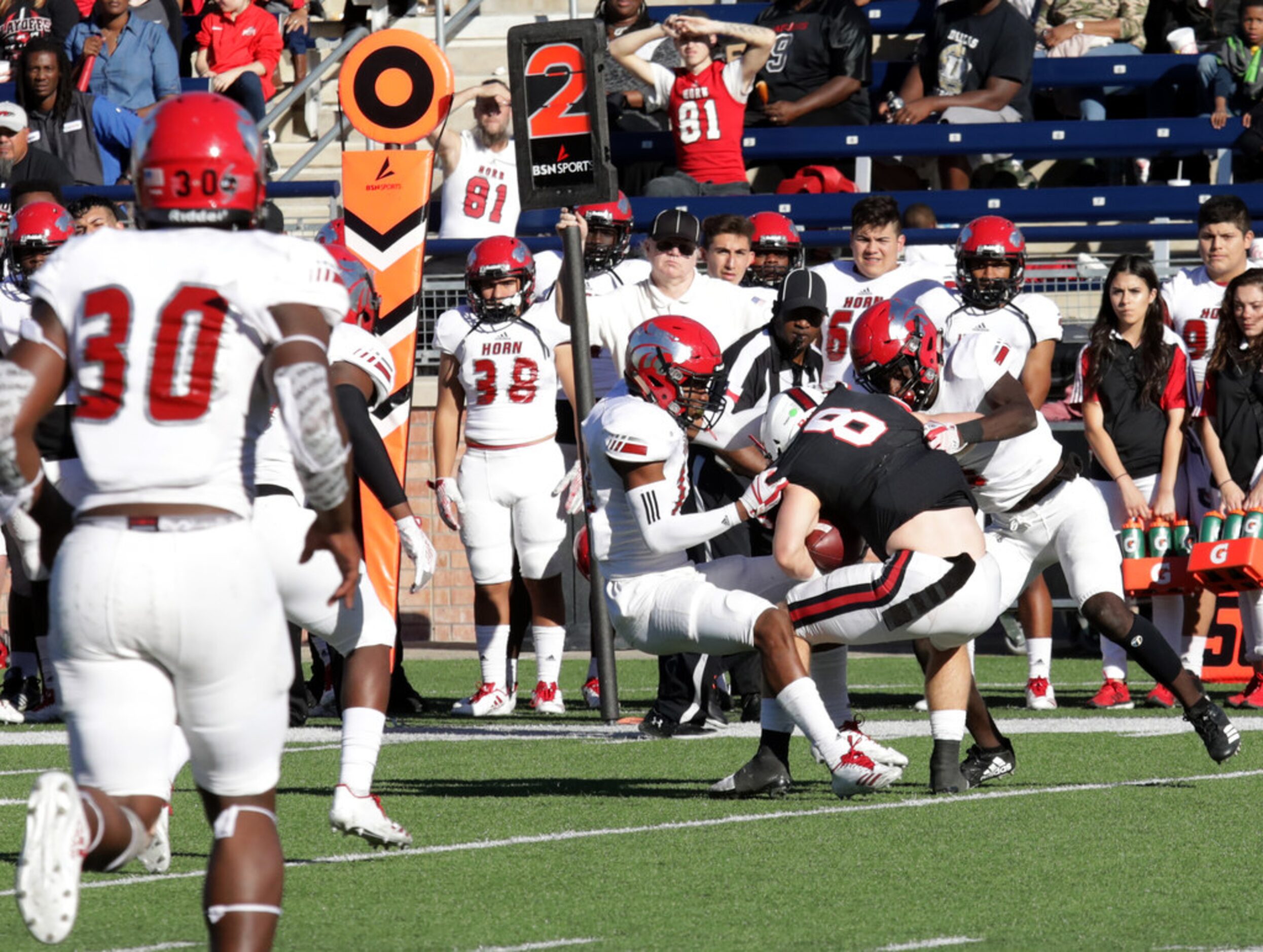 Coppell player 8, Blake Jackson, runs into a wall of Horn defensemen during a Class 6A...