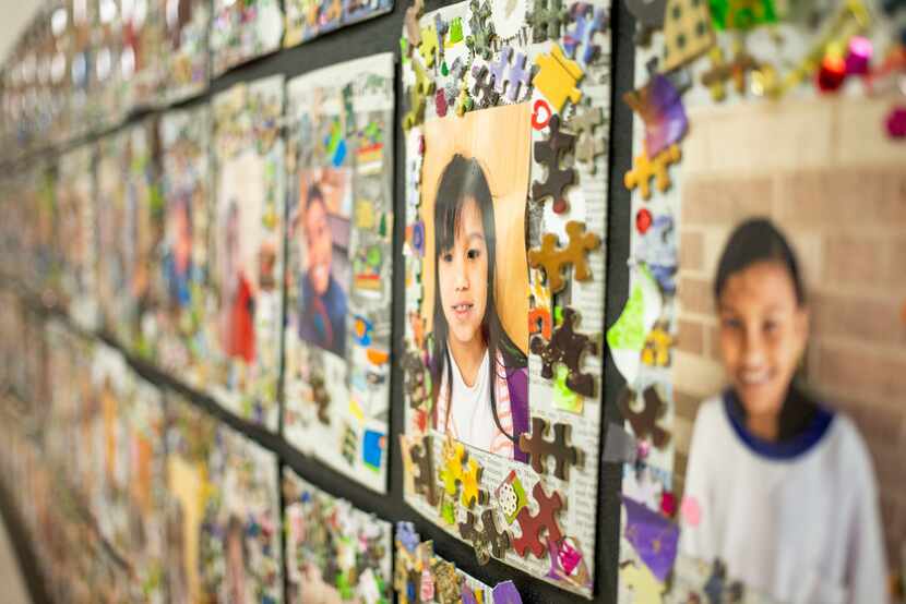 Pictures of DISD refugee summer program participants hang in the hallway at Sam Tasby Middle...