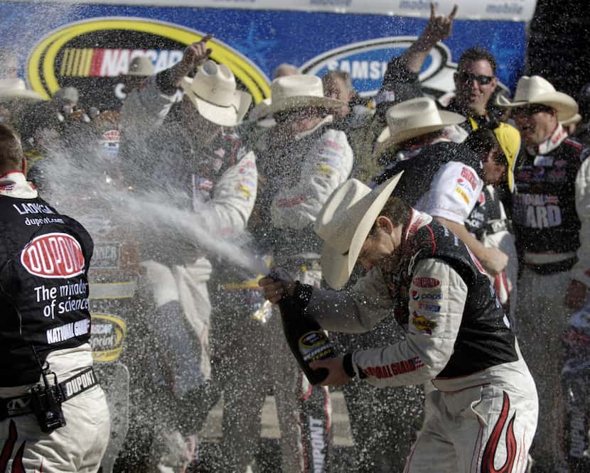 Jeff Gordon celebrates with his crewmen after winning the NASCAR Sprint Cup Series Samsung...