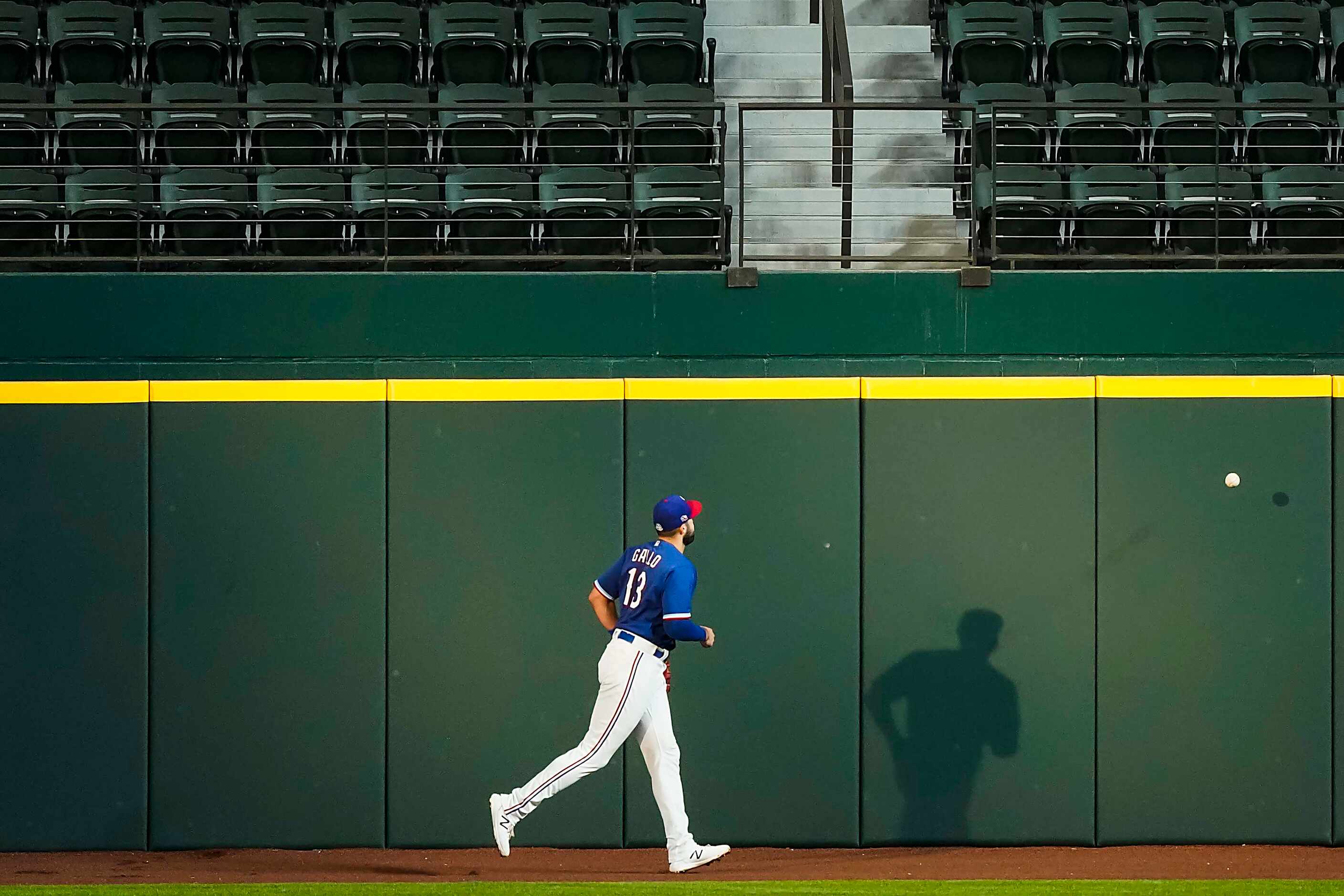 Texas Rangers outfielder Joey Gallo chases a home run ball off the bat of Colorado Rockies...