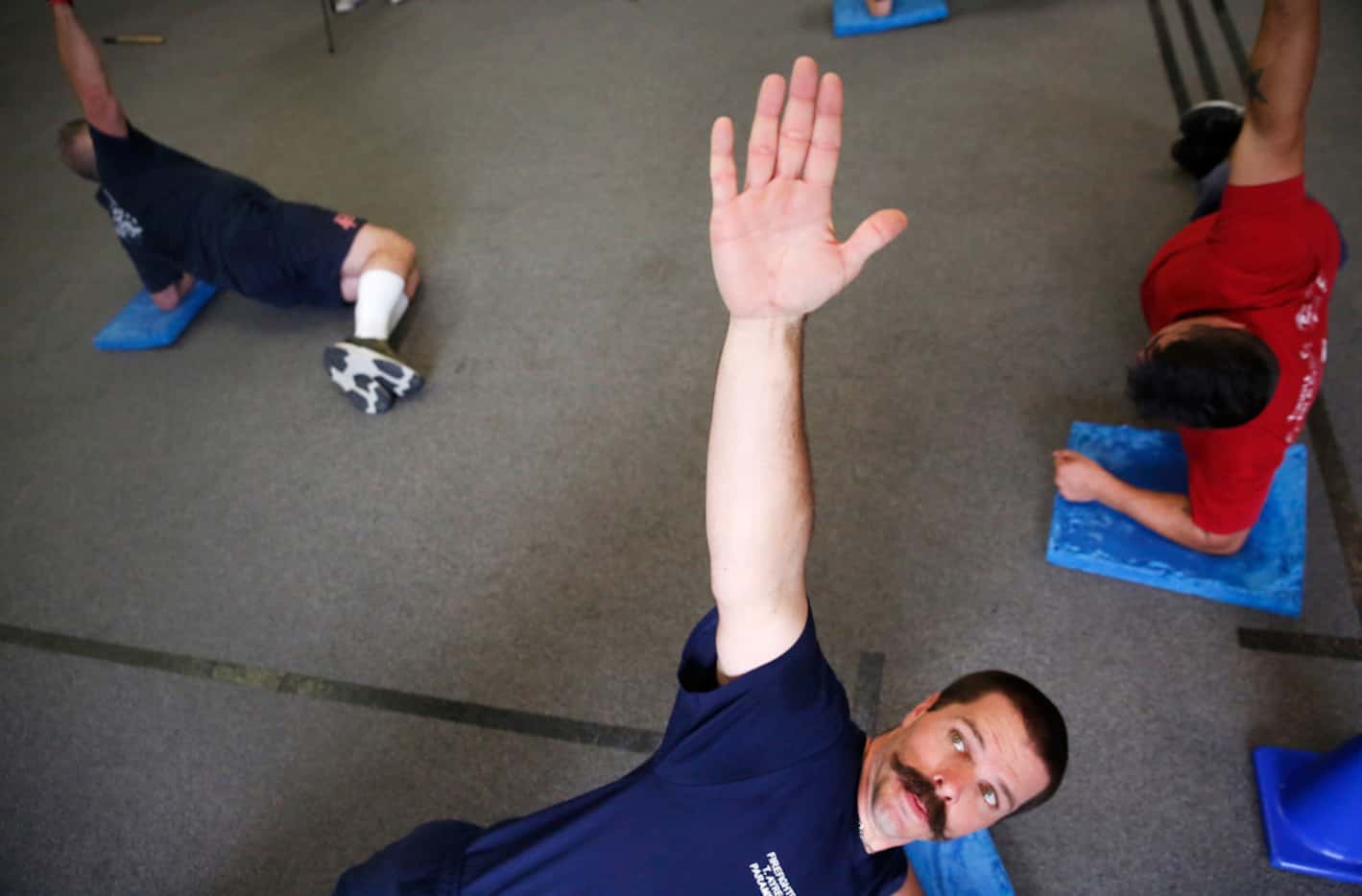 Addison firefighter/paramedic Troy Ayres holds a pose at REACT gym in Addison, Texas on...