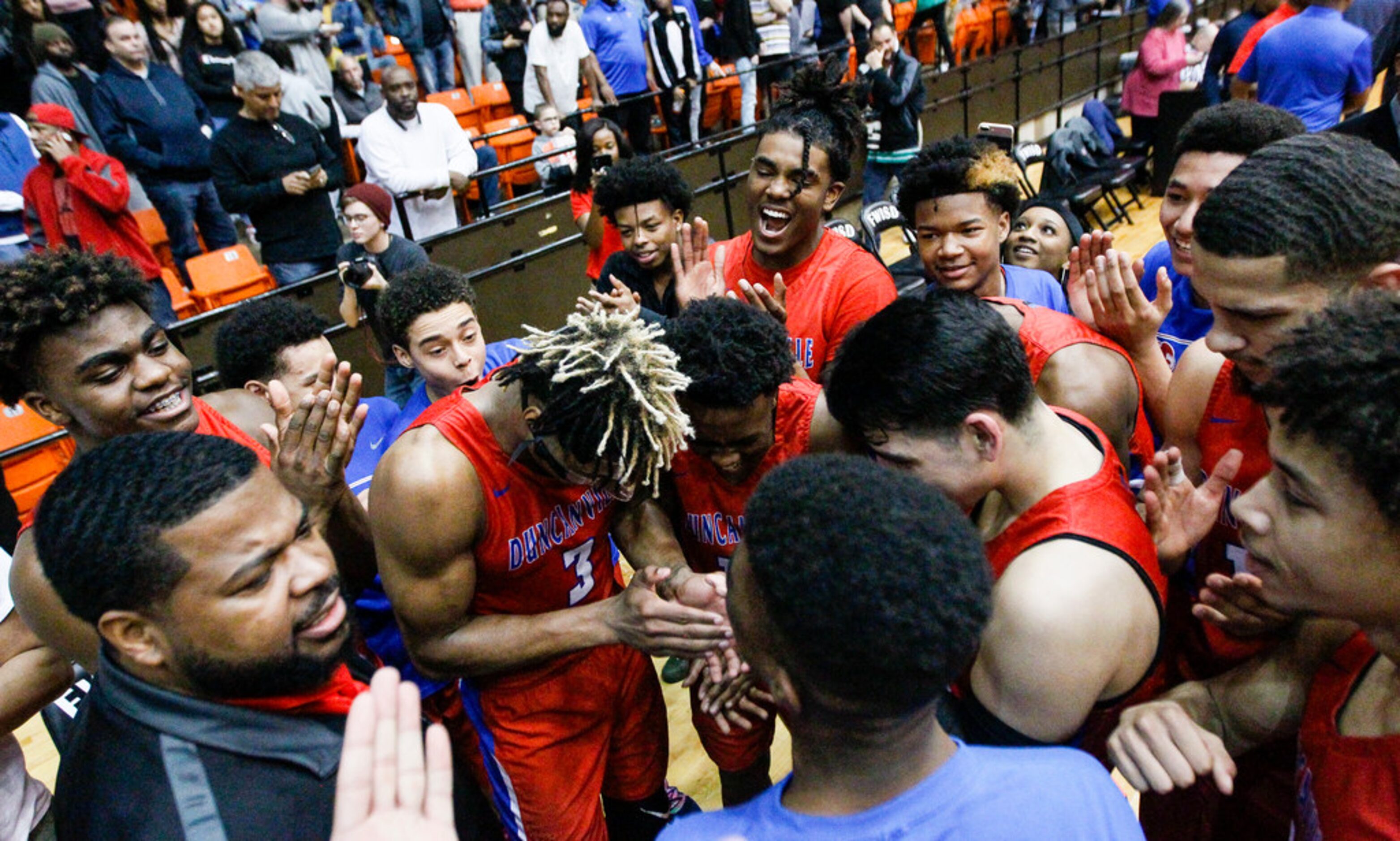 Duncanville celebrates a 61-60 overtime win in a boys Class 6A Region I quarterfinal...