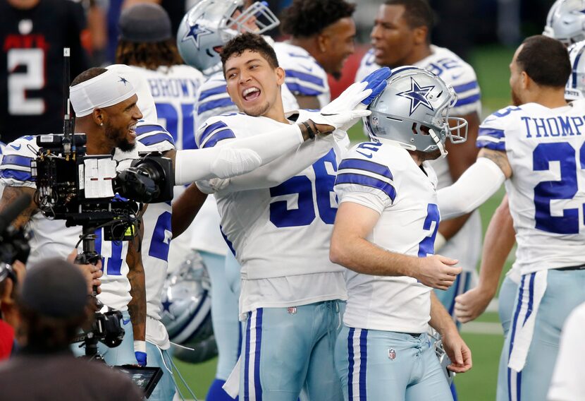 Cowboys wide receiver Malik Turner (17) and defensive end Bradlee Anae (56) congratulate...