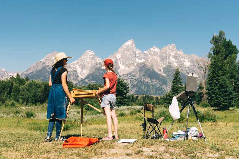 Visitors find an iconic scene to paint with the Grand Tetons near Jackson Hole, Wyo. 