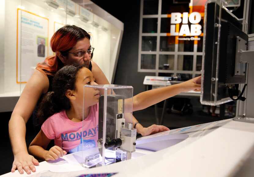 Janet Rodriguez and her daughter Sylvia Rodriguez, 9, of Spring check out an exhibit at the...