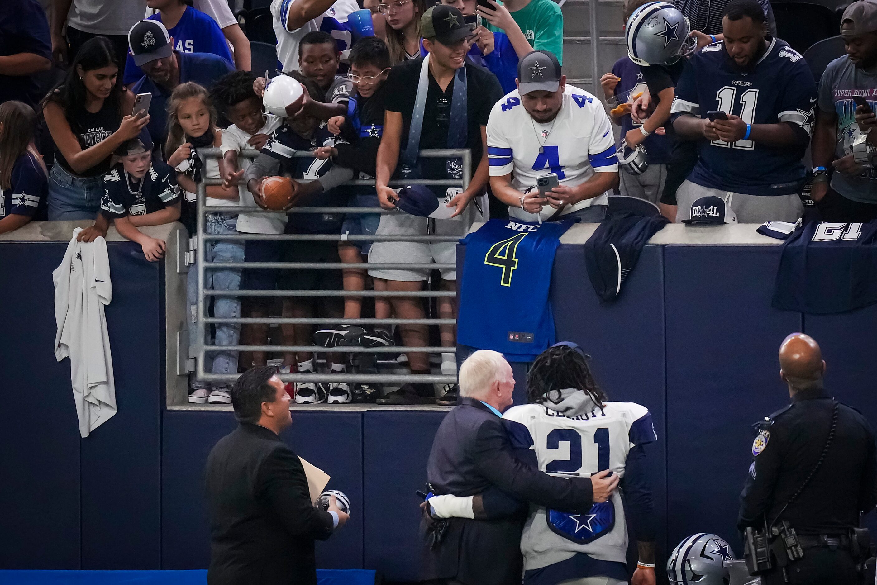 Dallas Cowboys owner and general manager Jerry Jones poses for fans with running back...