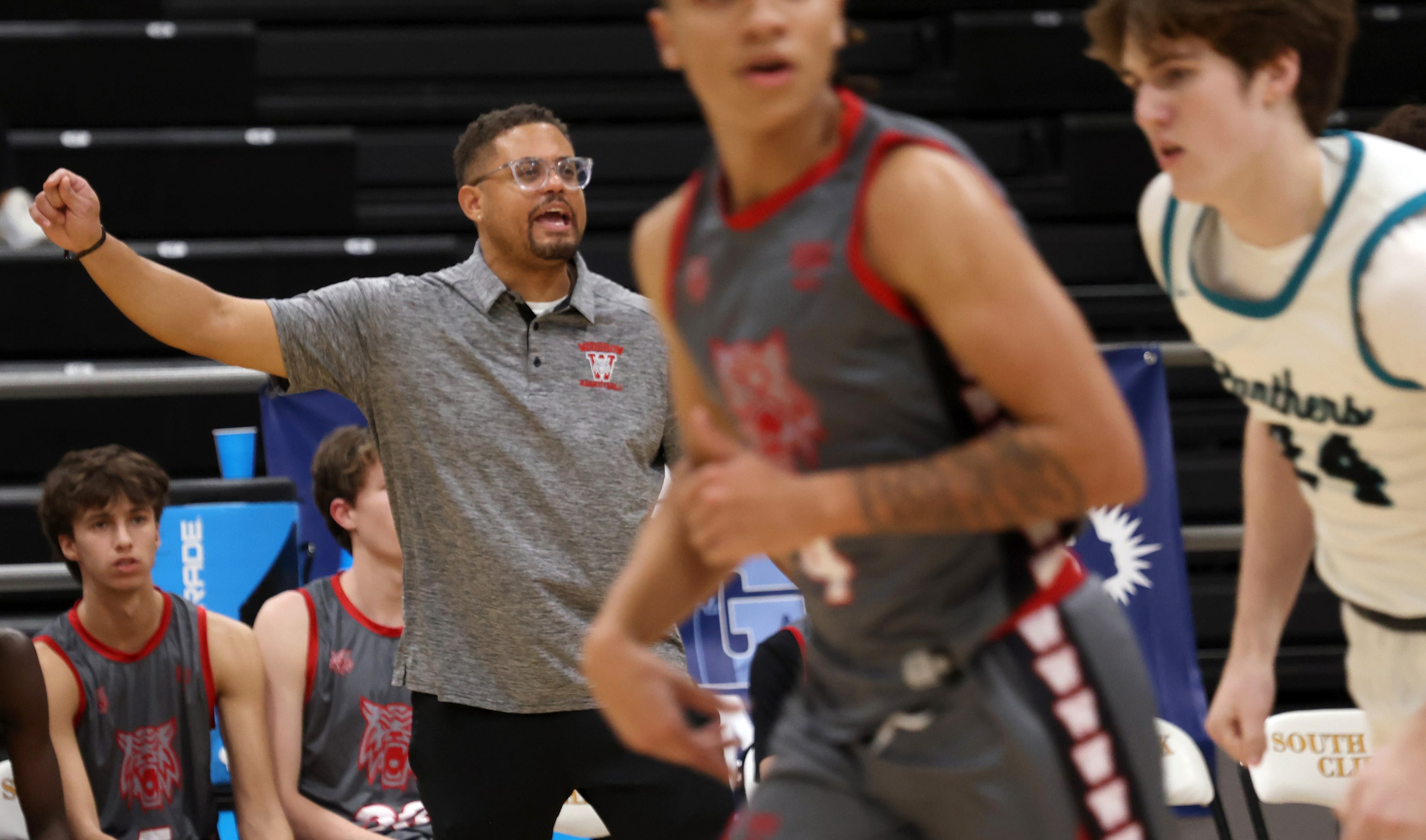 Dallas Woodrow Wilson head coach Billy Cunningham directs his players from the team bench...