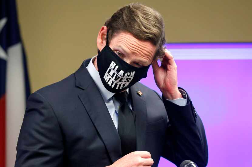 Dallas County Judge Clay Jenkins removes his Black Lives Matters mask to answer a question...