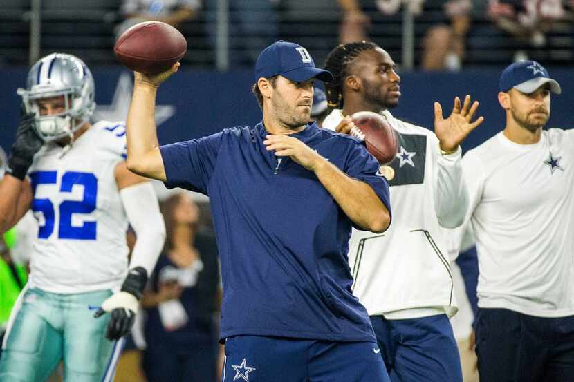 Dallas Cowboys quarterback Tony Romo tosses passes to free safety Byron Jones as the teams...
