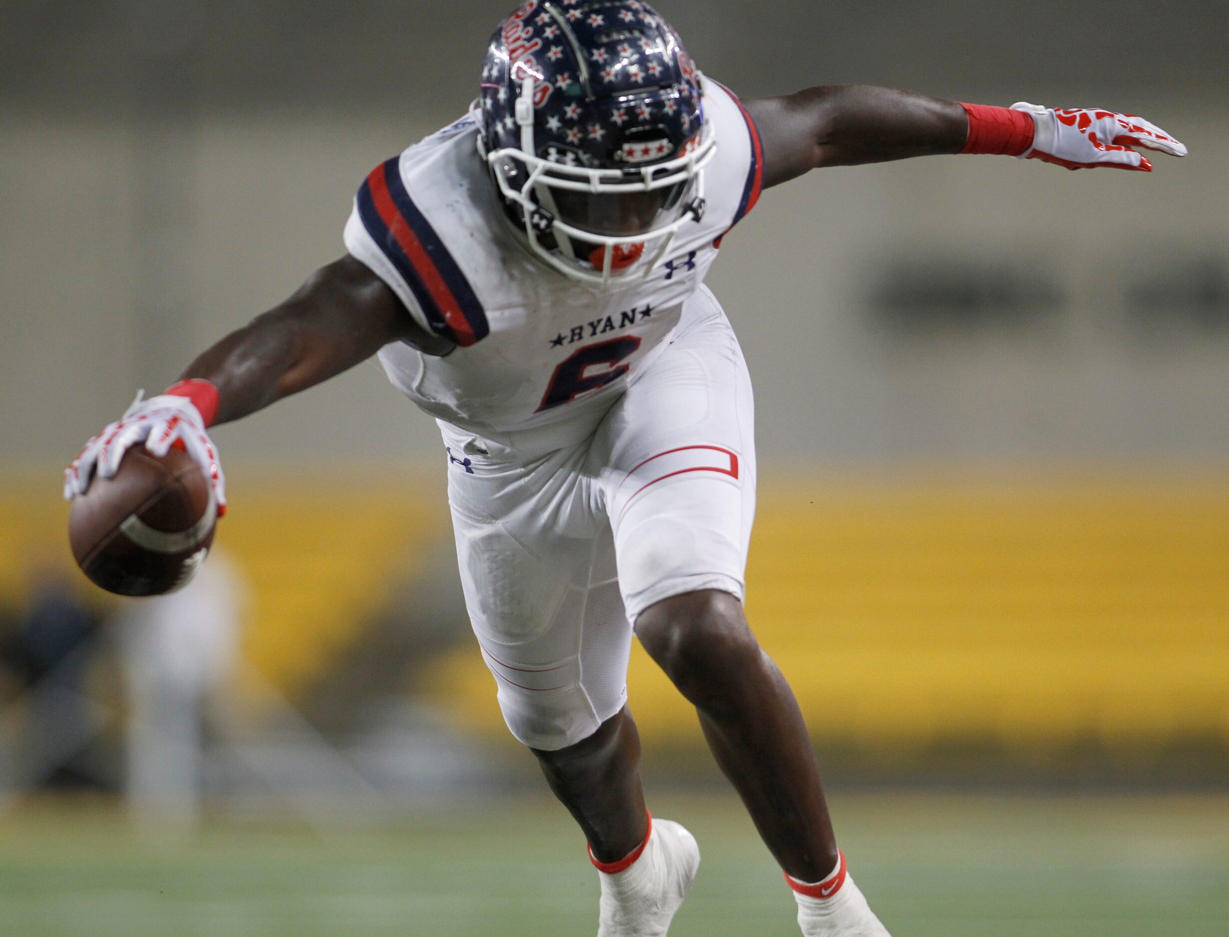 Denton Ryan running back Anthony Hill Jr. (6) lunges for extra yardage before going out of...