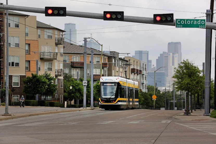 The Dallas streetcar approaches the intersection of Zang and Colorado as it ambles along its...