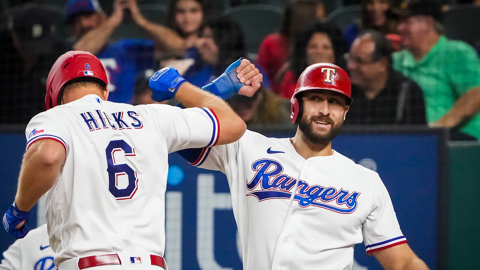 Texas Rangers catcher John Hicks celebrates with right fielder Joey Gallo after hitting a...