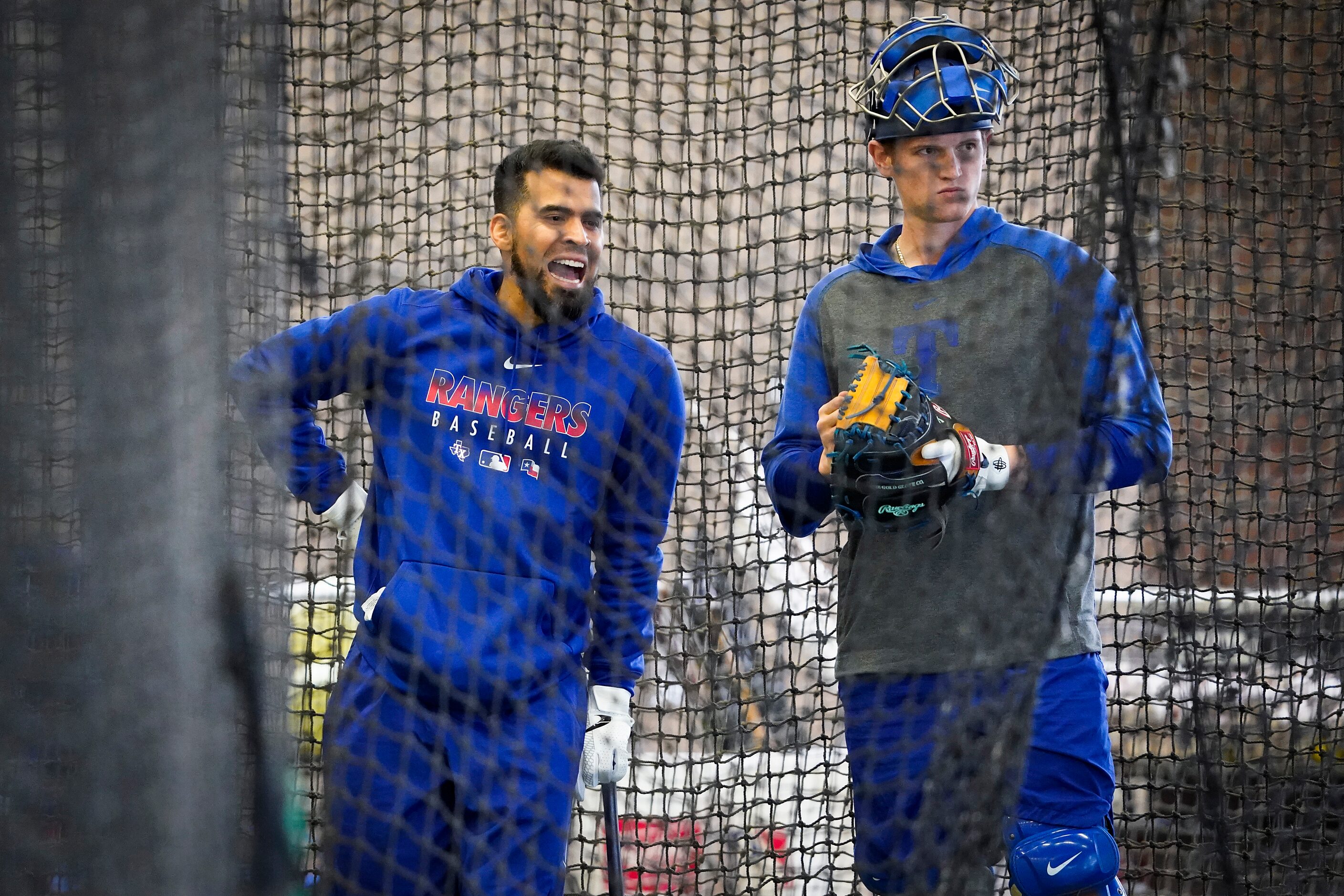 Texas Rangers catcher Robinson Chirinos (left) talks with catcher Sam Huff in the batting...