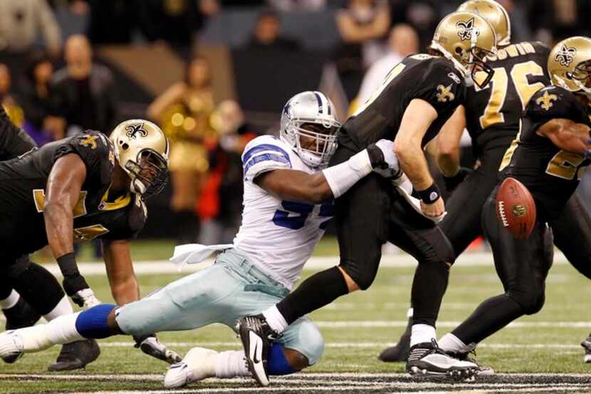 Cowboys linebacker DeMarcus Ware (94) causes Drew Brees (9) to fumble to end the Saints'...