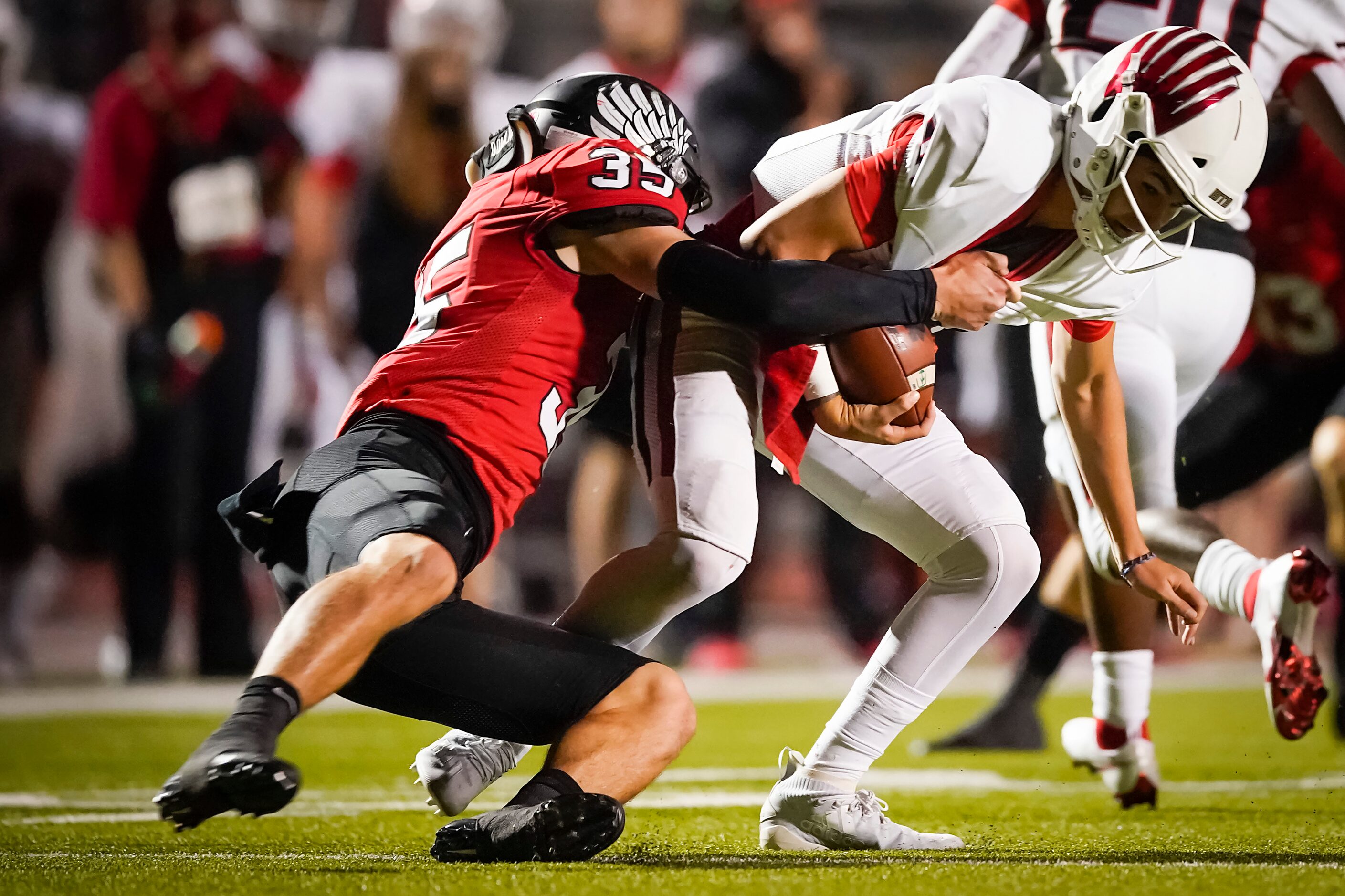 Melissa quarterback Sam Fennegan is dropped for a loss by Argyle linebacker Davis Elsey (35)...