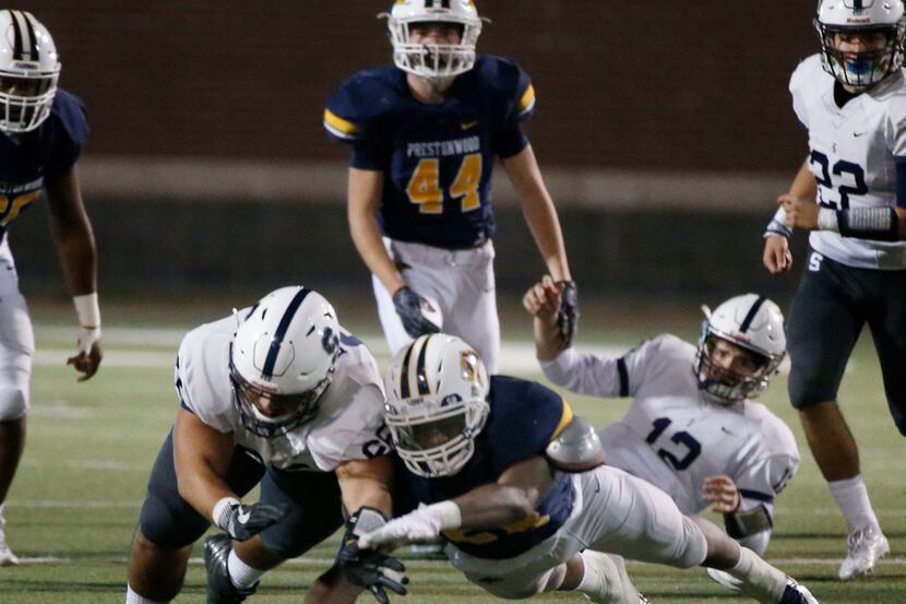 Prestonwood's Pierce DeVaughn (58) jump on a All-Saints fumble in front of All Saints player...