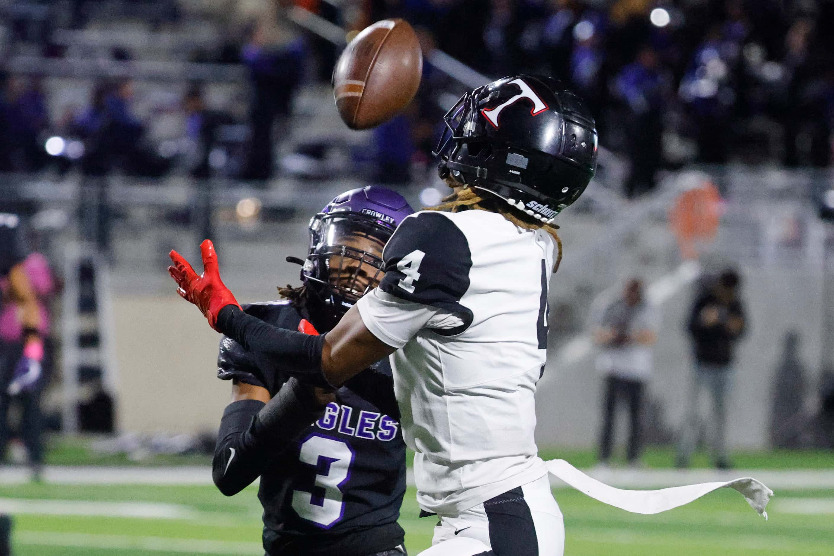 Crowley High’s Ja’Corian White (left) looks as Trinity High’s Jarvis Heimuli catches a pass...