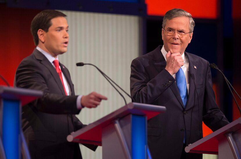 Republican Presidential candidate Florida Senator Marco Rubio (L) speaks as former Florida...