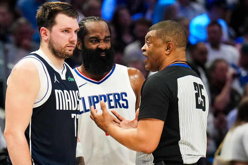 Dallas Mavericks guard Luka Doncic (77) and LA Clippers guard James Harden (1) talk with...