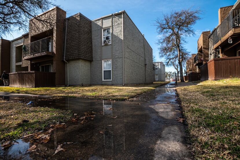 Sewer water flooded the sidewalks outside of units at Hillcrest Apartments in Mesquite in...